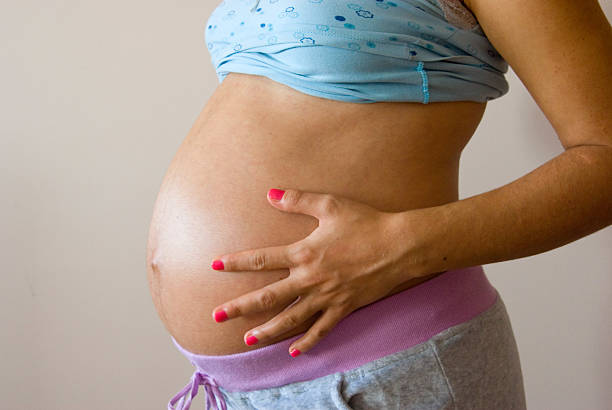 istock Pregnant Woman Holding Her Belly 2238524869