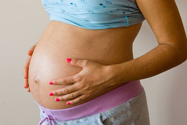 istock Pregnant Woman Holding Her Belly 2238524902