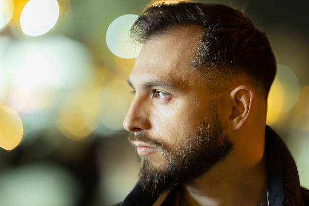 istock Young man looking ahead in urban night 2238525036