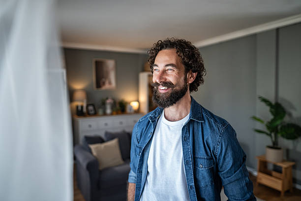 istock Happy man smiling looking away in home 2238528678