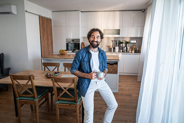 istock Man drinking coffee enjoying morning in modern kitchen 2238528878