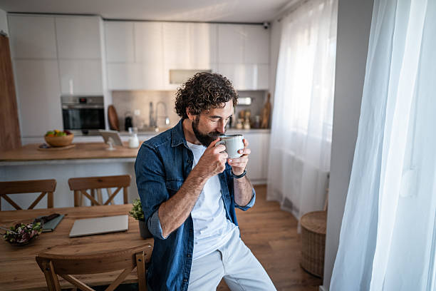 istock Man enjoying morning coffee in modern kitchen 2238528882