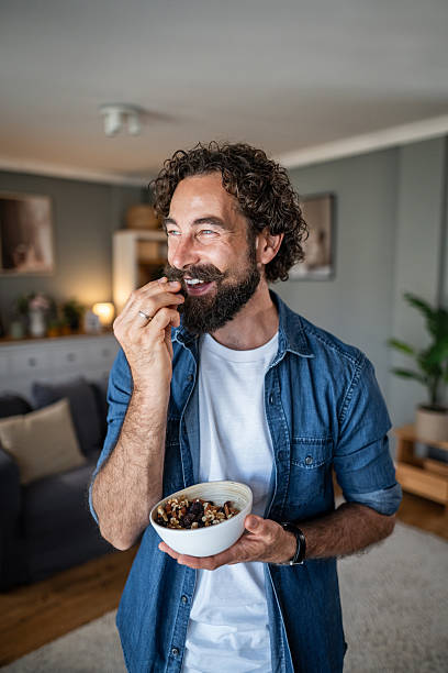 Man enjoying healthy trail mix snack at home