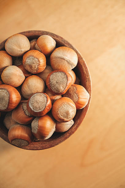 istock Harvested hazelnuts resting in a wooden bowl on a polished table 2238531776