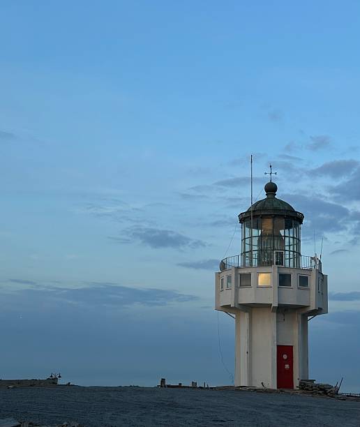 istock White Lighthouse at Twilight Against a Moody Blue Sky, Vertical Frame 2238533010