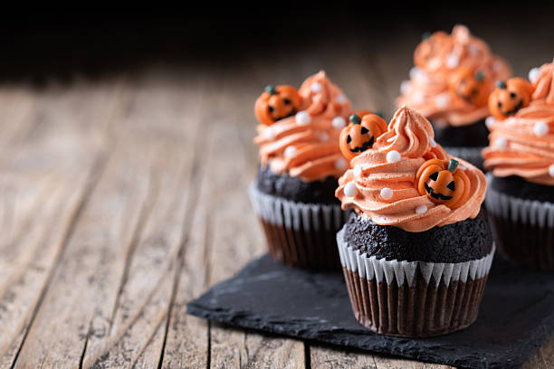 istock Halloween cupcakes with Halloween sprinkles on wooden table 2238534257