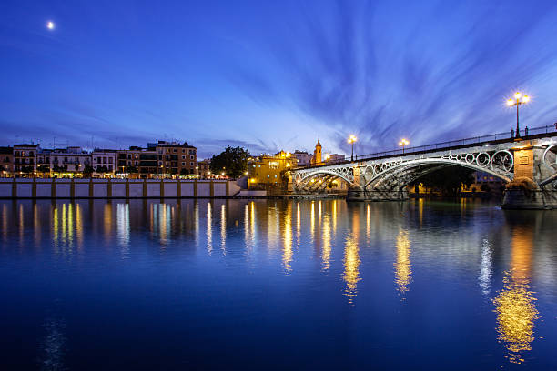 istock Crescent moon rises over Triana Bridge at dusk in Seville 2238536199