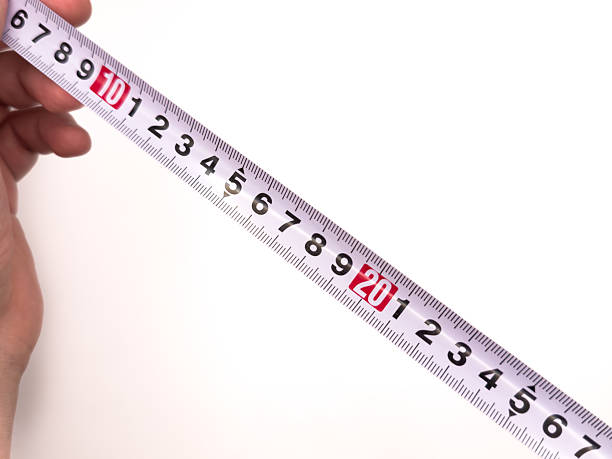 istock A measuring tape, a ruler, a construction site, a white background. A man holding a tape measure. Measuring instrument, repair. 2238538103