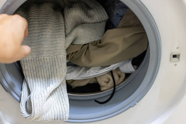 istock Laundry Load in Front-Loading Washer With Knitwear and Everyday Clothes at Home 2238539944