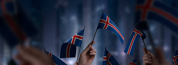 istock Iceland flags in their hands on a blurred urban background 2238540398