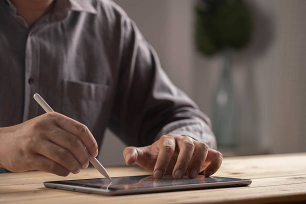 istock Close-up of businessman using digital tablet with stylus pen, representing online work, digital creativity, modern technology, remote office, productivity tools, and innovative business solutions. 2238542050