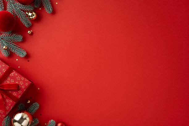 istock A festive red backdrop frames wrapped presents, pine sprigs, and gold ornaments, evoking Christmas and New Year warmth. Perfect for seasonal greetings, holiday marketing, and celebration themes 2238543650
