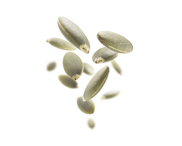 istock Peeled pumpkin seeds levitate on a white background 2238543748