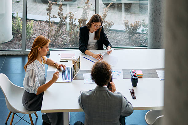 istock Business people collaborating on project in modern office 2238546746