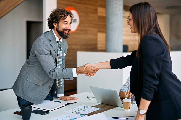 istock Business people shaking hands making a deal in office 2238546757