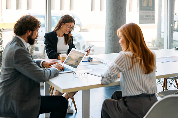 istock Business professionals collaborating in modern office with technology 2238546795
