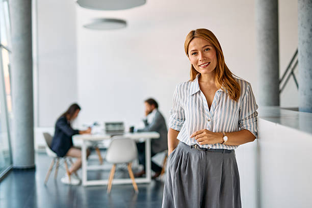 istock Businesswoman smiling standing in modern office environment 2238546850