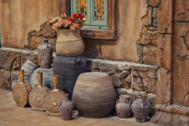 istock Beautiful vases are elegantly placed on the sidewalk next to a stone wall 2238548424