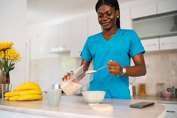 istock Young black nurse preparing oatmeal breakfast in modern kitchen 2238549845