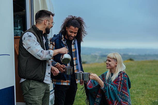 istock Three friends next to a camper van, enjoying some tea 2238550706