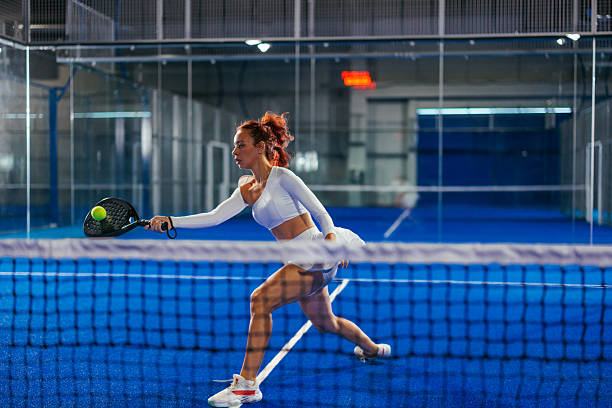istock Female padel player playing a difficult forehand on the net 2238550786