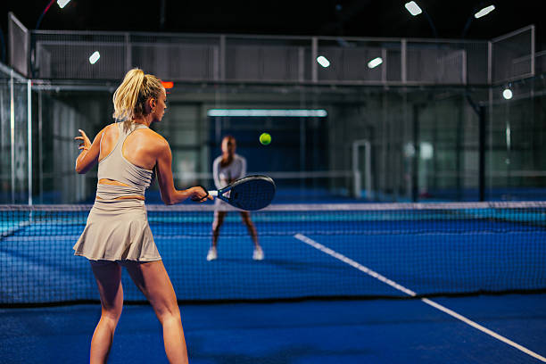 Rear view of female padel player displaying skill and precision
