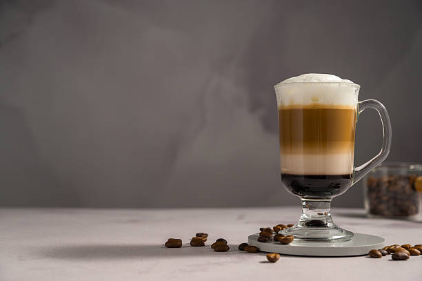 istock Layered coffee latte drinks. Hot coffee drinks in glass mugs, copy space 2238550933