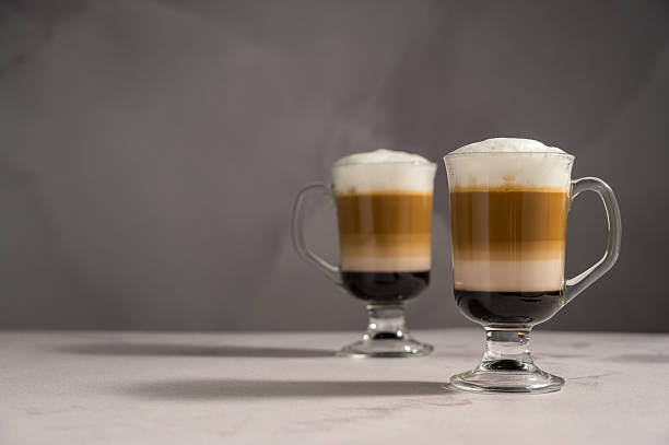 istock Layered coffee latte drinks. Hot coffee drinks in glass mugs, copy space 2238550964