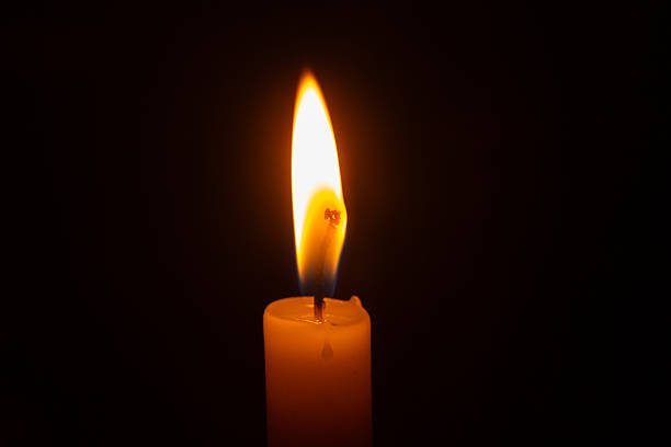 istock Close up of a lit candle flame. 2238551051