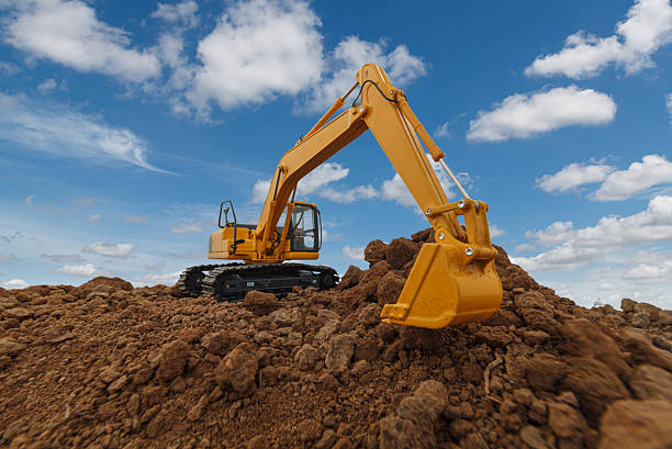 Selective focus with Bucket ,Excavator  are digging  soil in the construction site .