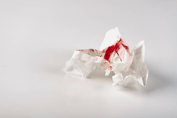 istock Fresh red blood stained on tissue paper on white table 2238551908