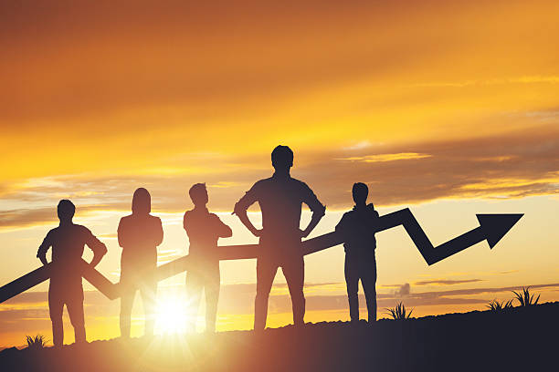 istock Team silhouette and up graph arrow on sunset background, leadership and teamwork concept 2238552488