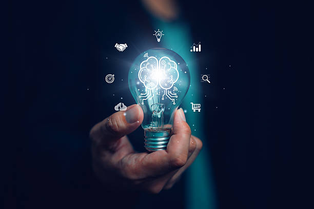 istock Businessman holding glowing light bulb with brain and AI circuit graphics, symbolizing artificial intelligence, innovation, smart technology and future business solutions. 2238556893