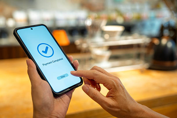 istock Person completing cashless payment using smartphone 2238559091