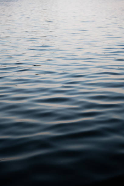 istock Calm water surface with gentle ripples reflecting soft light 2238560328