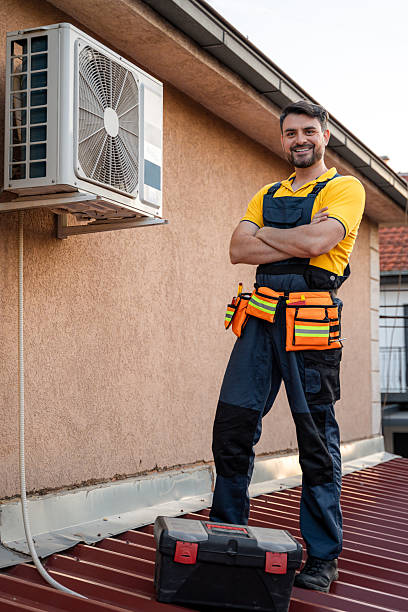 istock Technician works on roof with air conditioning unit during late afternoon 2238560695