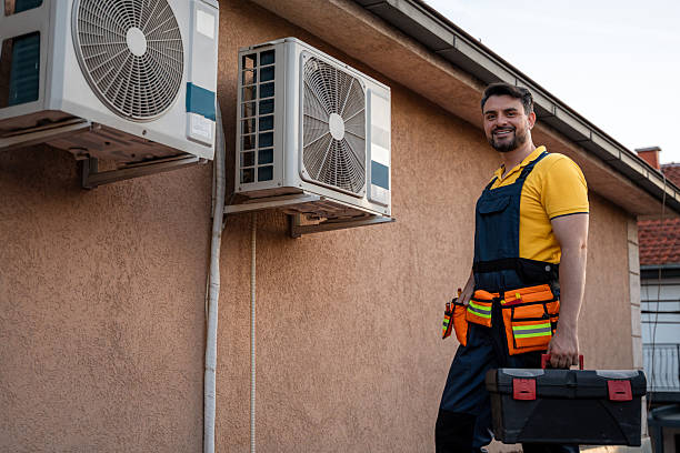 istock Man wearing work uniform fixing air conditioning units on a building in sunny weather 2238560925