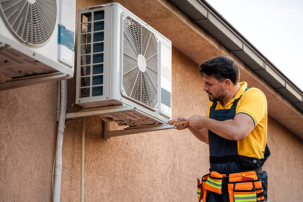 istock Technician repairs air conditioning unit on warm afternoon 2238561253