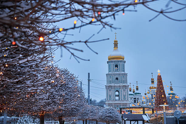istock Christmas tree with lights outdoors at night in Kiev. Sophia Cathedral on background. 2238564243