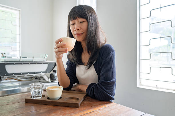 Woman having coffee tasting experience in a cafe