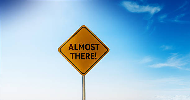 Almost there road sign isolated on blue sky background