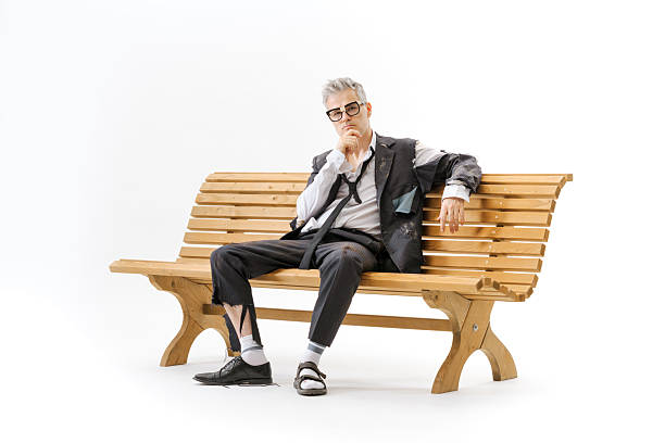 istock Unemployed homeless businessman sitting on a bench 2238569755