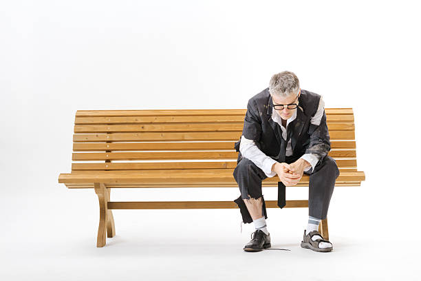 istock Unemployed homeless businessman sitting on a bench 2238569927