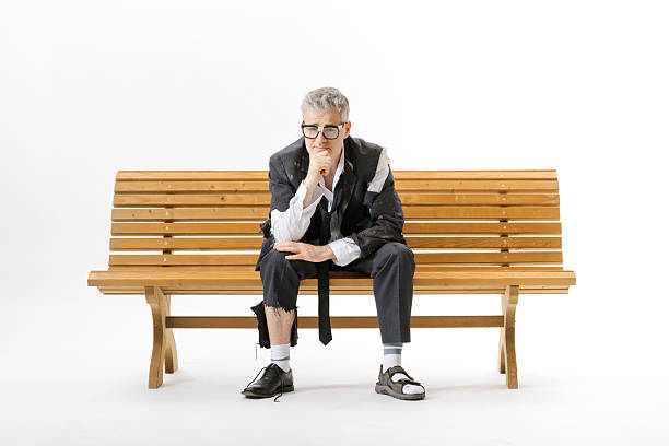 istock Unemployed homeless businessman sitting on a bench 2238570044