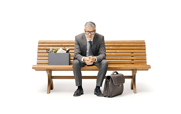 One young handsome businessman sitting on the bench downtown in the city.