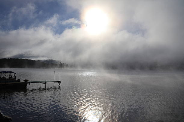 istock Sunrise Piercing Through the Fog Over Canada Lake 2238570238