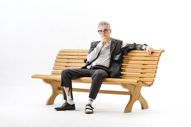 istock Unemployed homeless businessman sitting on a bench 2238570272