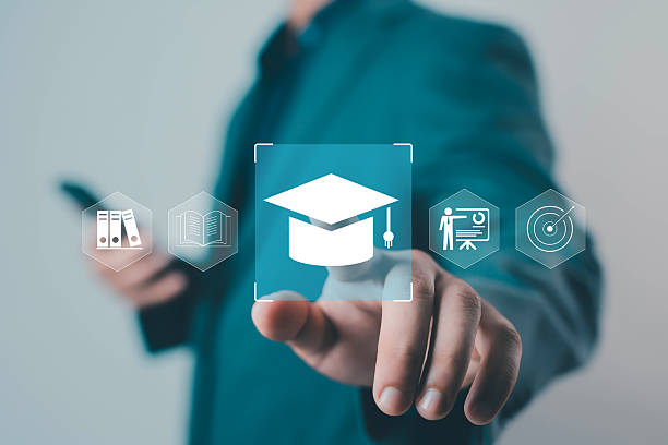 istock Businessman touching virtual graduation cap icon representing online education, e-learning, digital training, and academic success with modern technology and innovation e-learning, intelligence, 2238571270