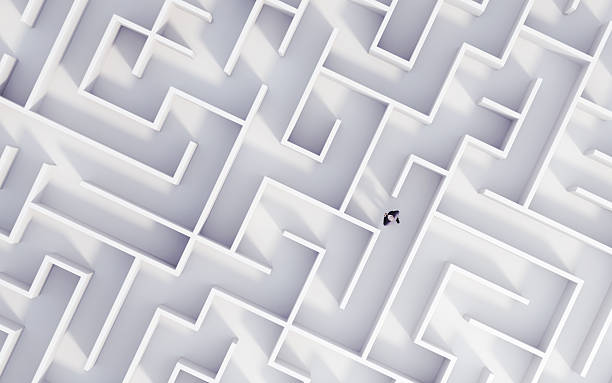 istock Following the Red-Lighted Exit Path in a Dark Concrete Square-Shaped Maze 2238571866