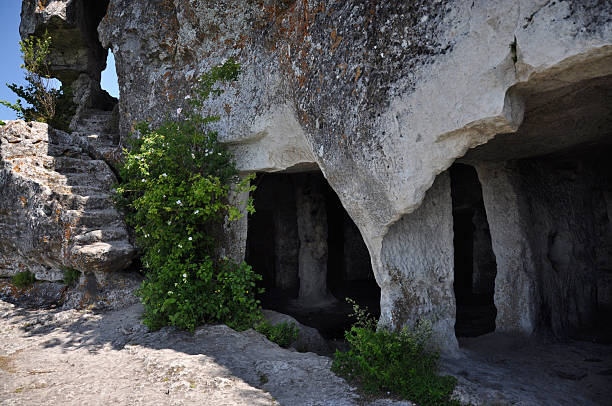 istock Ancient cave settlement with rock-cut chambers, stone stairs and carved columns in limestone, medieval archaeological site, cultural heritage, historic ruins, hiking and exploration travel photography 2238574809